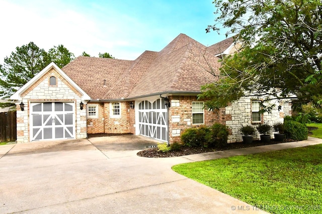 2463 S Park Hl, Tahlequah, OK 74464 - view of front of home featuring concrete driveway, roof with shingles, an attached garage, stone siding, and a front yard