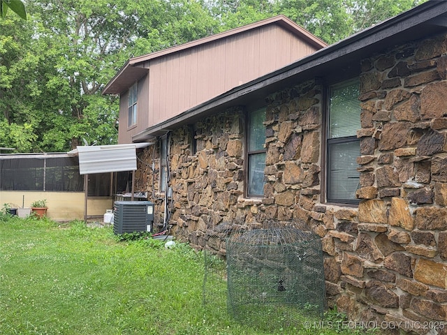 14177 E 590th Rd S, Inola, OK 74036 - view of home's exterior featuring stone siding, a sunroom, and a yard