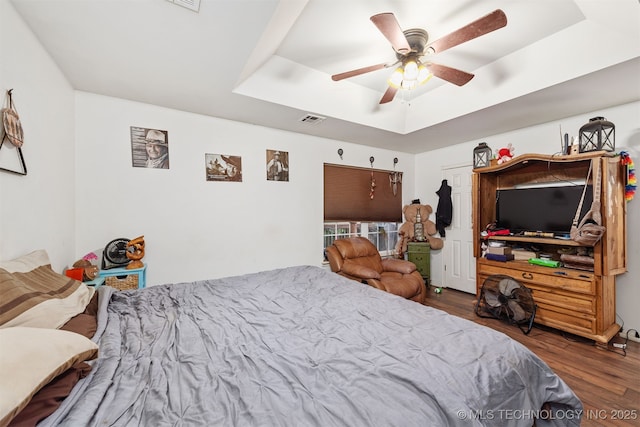 30103 S 4210th Rd, Inola, OK 74036 - bedroom featuring a raised ceiling, wood finished floors, and a ceiling fan