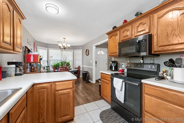30103 S 4210th Rd, Inola, OK 74036 - kitchen with black appliances, a chandelier, light countertops, and a peninsula