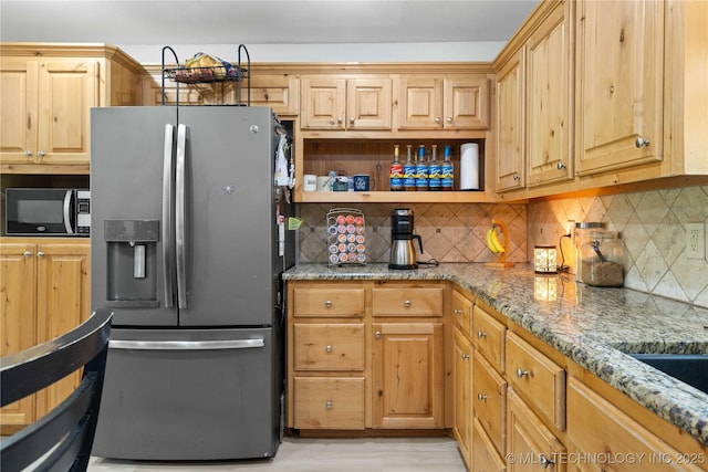 110094 S 4680th Rd, Gans, OK 74936 - kitchen with stainless steel fridge with ice dispenser, black microwave, light stone counters, and decorative backsplash