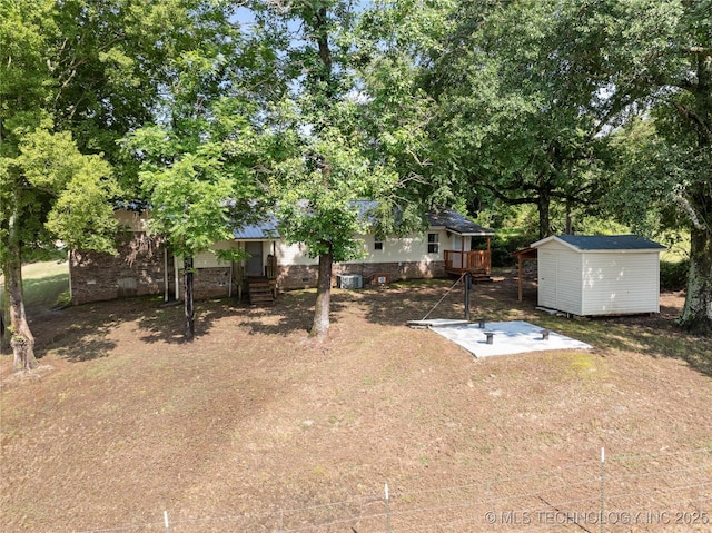110094 S 4680th Rd, Gans, OK 74936 - view of yard featuring a storage unit, a deck, and view of scattered trees