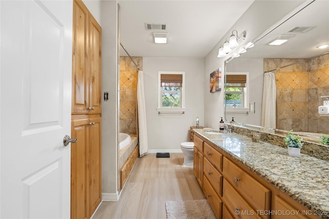 110094 S 4680th Rd, Gans, OK 74936 - full bathroom featuring vanity, wood finished floors, and tiled shower / bath combo
