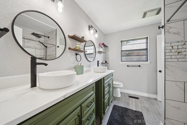 2331 S 99th E Ave, Tulsa, OK 74129 - full bathroom with double vanity, a shower, and a textured wall