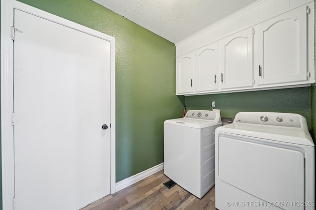 2331 S 99th E Ave, Tulsa, OK 74129 - washroom featuring cabinet space, independent washer and dryer, wood finished floors, a textured ceiling, and a textured wall