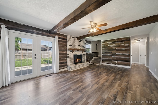 2331 S 99th E Ave, Tulsa, OK 74129 - unfurnished living room with a textured ceiling, french doors, wood finished floors, healthy amount of natural light, and a ceiling fan