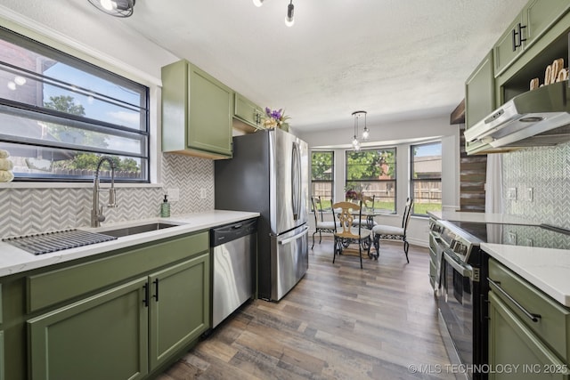 2331 S 99th E Ave, Tulsa, OK 74129 - kitchen with green cabinets, stainless steel appliances, dark wood finished floors, and decorative backsplash