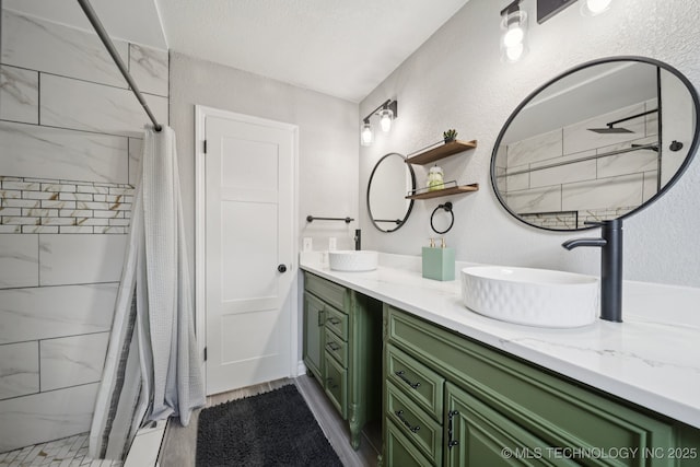 2331 S 99th E Ave, Tulsa, OK 74129 - full bath with a tile shower, double vanity, and a textured wall