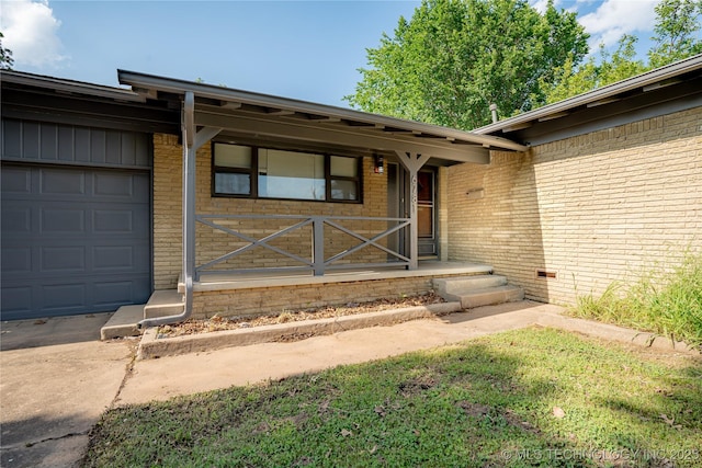 6781 E 26th Pl, Tulsa, OK 74129 - entrance to property with brick siding and an attached garage