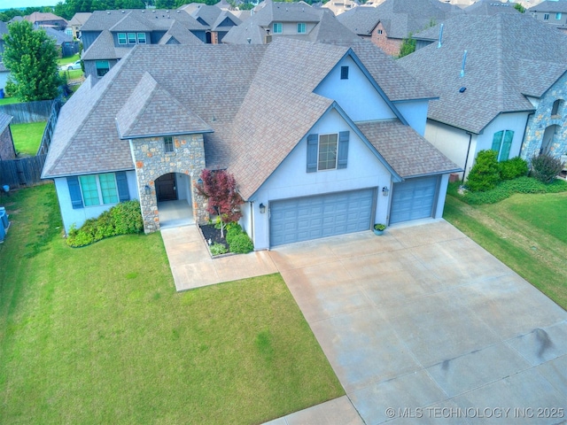 5815 E 144th St S, Bixby, OK 74008 - view of front of property featuring stucco siding, stone siding, driveway, roof with shingles, and a residential view