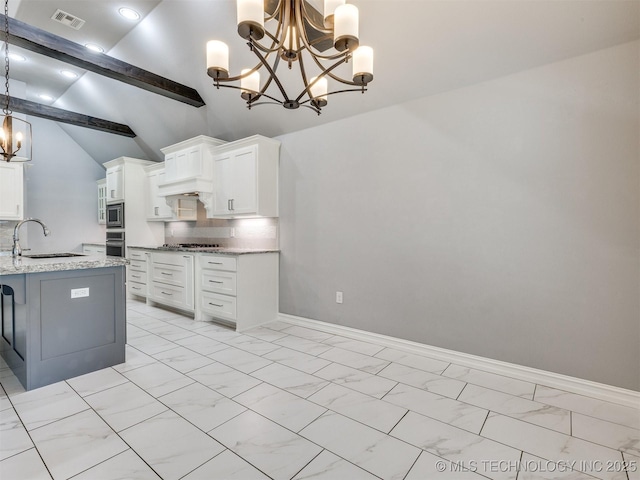 5815 E 144th St S, Bixby, OK 74008 - kitchen featuring a chandelier, appliances with stainless steel finishes, light marble finish floors, and white cabinetry
