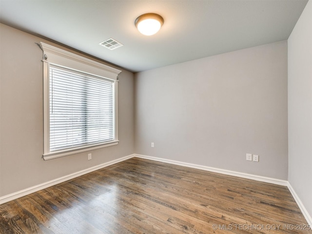 5815 E 144th St S, Bixby, OK 74008 - spare room featuring baseboards and dark wood-style flooring