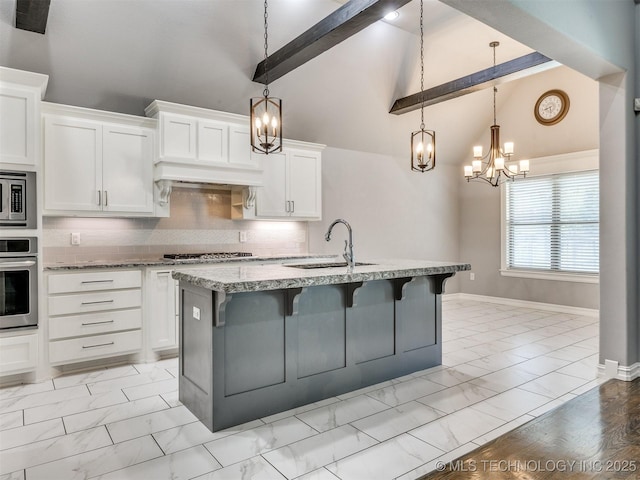 5815 E 144th St S, Bixby, OK 74008 - kitchen with stainless steel appliances, light marble finish floors, a chandelier, white cabinetry, and beam ceiling