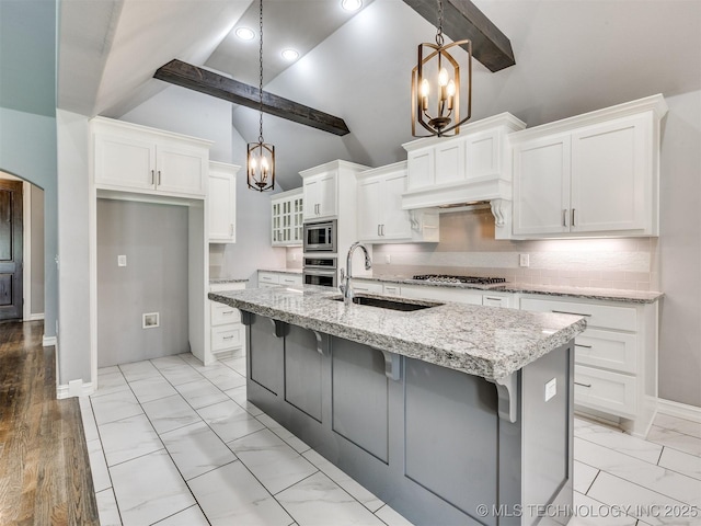 5815 E 144th St S, Bixby, OK 74008 - kitchen featuring a chandelier, appliances with stainless steel finishes, beamed ceiling, white cabinetry, and backsplash
