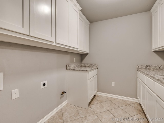 5815 E 144th St S, Bixby, OK 74008 - laundry area featuring cabinet space, hookup for an electric dryer, and light tile patterned floors