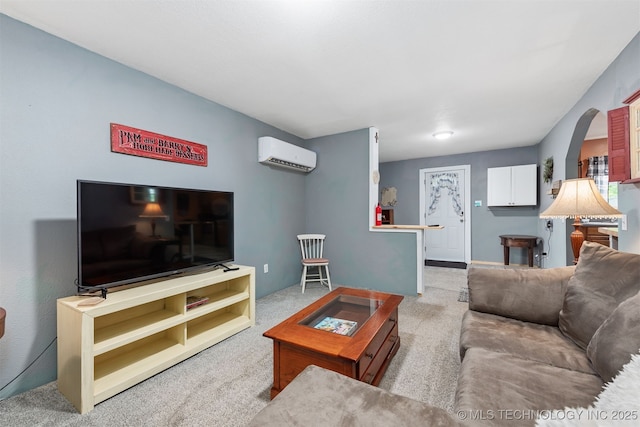 6607 Old Taft Rd, Muskogee, OK 74401 - living area featuring a wall unit AC, carpet floors, and arched walkways