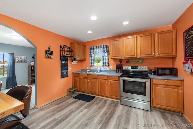 6607 Old Taft Rd, Muskogee, OK 74401 - kitchen with stainless steel electric range oven, arched walkways, black microwave, light wood-style floors, and recessed lighting