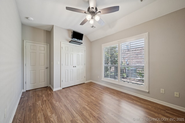 4205 N Narcissus Ave, Broken Arrow, OK 74012 - unfurnished bedroom with wood finished floors, a closet, lofted ceiling, and ceiling fan