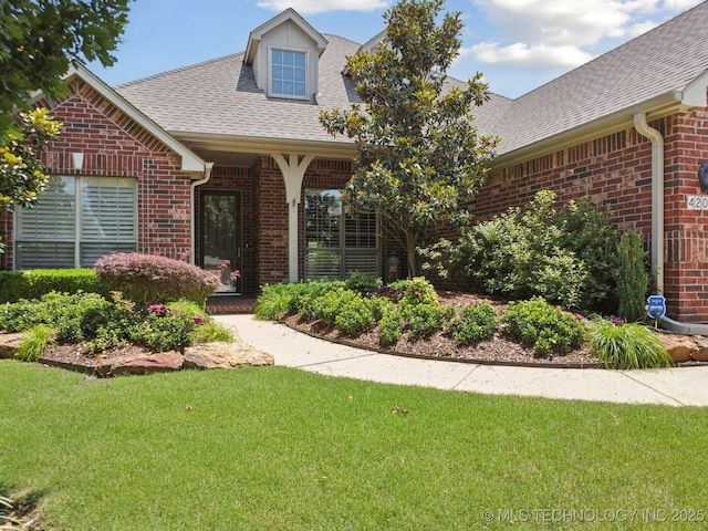 4205 N Narcissus Ave, Broken Arrow, OK 74012 - view of front facade featuring brick siding, roof with shingles, and a front yard