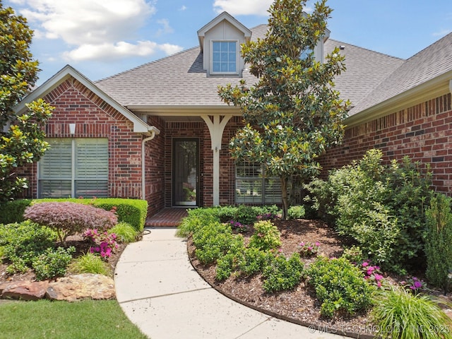 4205 N Narcissus Ave, Broken Arrow, OK 74012 - property entrance featuring brick siding and a shingled roof