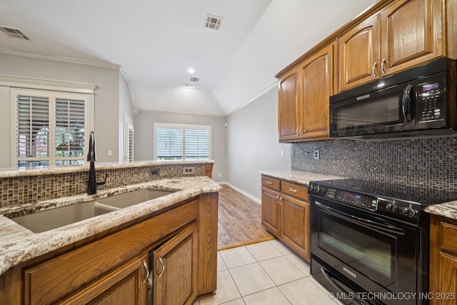 4205 N Narcissus Ave, Broken Arrow, OK 74012 - kitchen featuring black appliances, light stone counters, backsplash, lofted ceiling, and brown cabinets