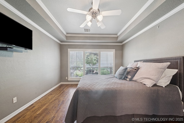 4205 N Narcissus Ave, Broken Arrow, OK 74012 - bedroom featuring wood finished floors, a tray ceiling, ornamental molding, a ceiling fan, and a textured wall