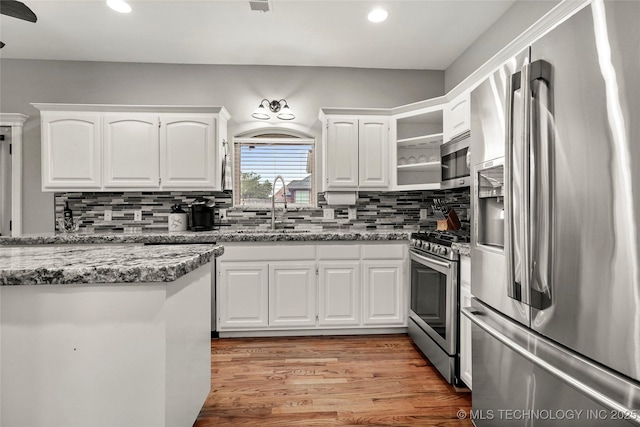 8905 N 137th E Ave, Owasso, OK 74055 - kitchen featuring stainless steel appliances, recessed lighting, light wood finished floors, white cabinetry, and backsplash