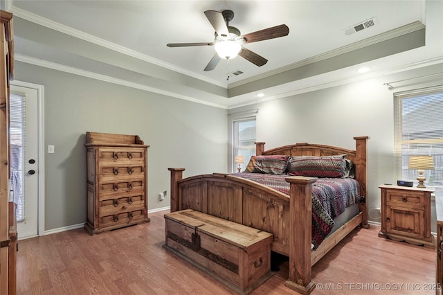 8905 N 137th E Ave, Owasso, OK 74055 - bedroom with light wood-type flooring, a ceiling fan, crown molding, and a tray ceiling