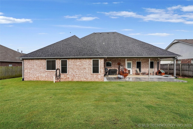 8905 N 137th E Ave, Owasso, OK 74055 - back of property featuring roof with shingles, a patio area, a fenced backyard, and brick siding