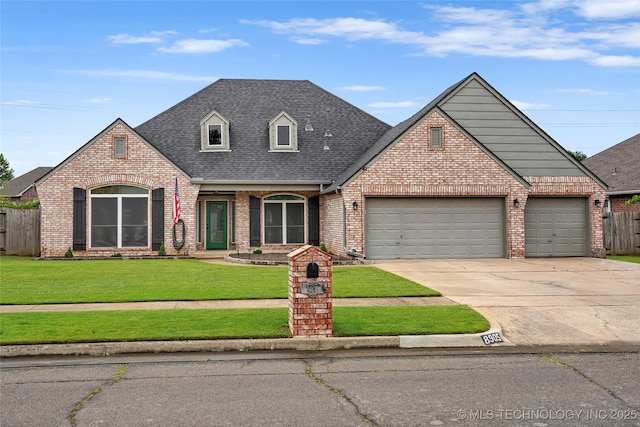 8905 N 137th E Ave, Owasso, OK 74055 - view of front of property featuring brick siding, roof with shingles, an attached garage, and concrete driveway