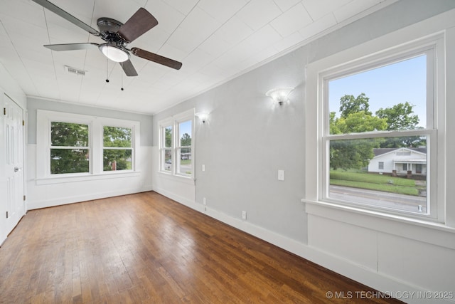 1601 E 6th St, Okmulgee, OK 74447 - empty room with ceiling fan and hardwood / wood-style flooring