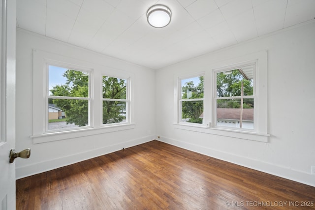 1601 E 6th St, Okmulgee, OK 74447 - spare room with healthy amount of natural light and dark wood-style floors