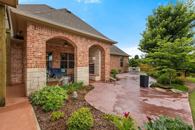 800 Magnolia, Ada, OK 74820 - view of patio / terrace with a fireplace and a ceiling fan