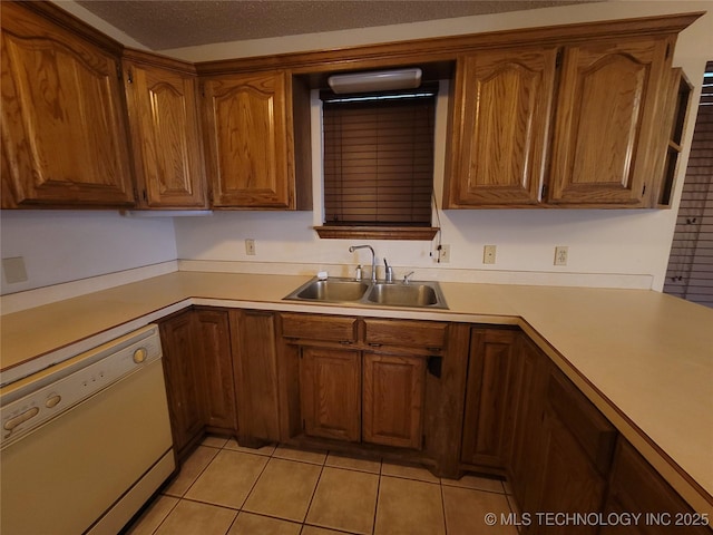 428101 E 1150th Rd, Porum, OK 74455 - kitchen featuring dishwasher, light tile patterned flooring, brown cabinetry, and light countertops