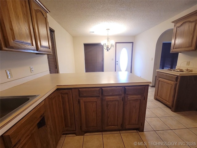 428101 E 1150th Rd, Porum, OK 74455 - kitchen featuring a peninsula, light countertops, a chandelier, and a textured ceiling