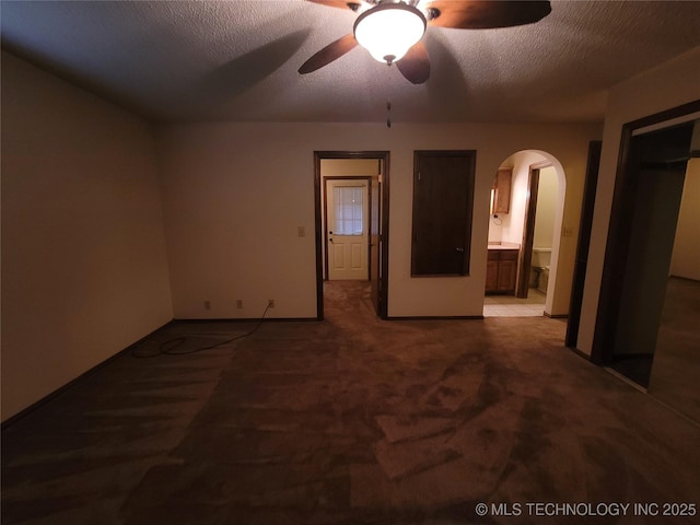428101 E 1150th Rd, Porum, OK 74455 - unfurnished room with arched walkways, a ceiling fan, and a textured ceiling