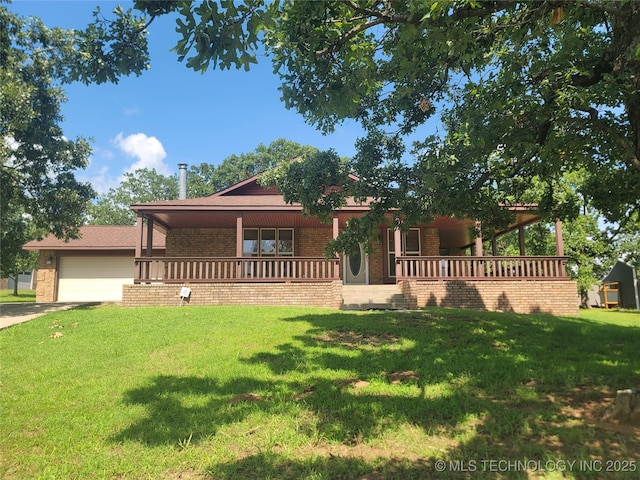 428101 E 1150th Rd, Porum, OK 74455 - view of front of home with a porch, brick siding, a front lawn, a garage, and driveway