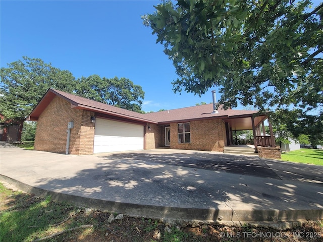 428101 E 1150th Rd, Porum, OK 74455 - view of front of property featuring brick siding, an attached garage, and driveway