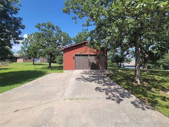 428101 E 1150th Rd, Porum, OK 74455 - view of front of home with a front lawn, an outbuilding, a garage, and driveway