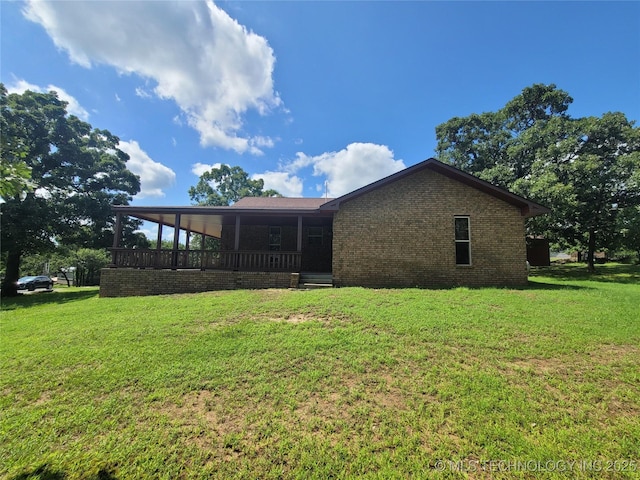 428101 E 1150th Rd, Porum, OK 74455 - rear view of house featuring brick siding and a yard