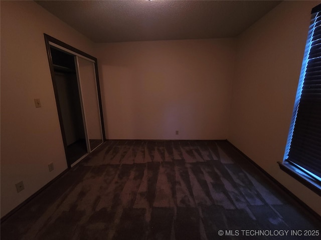 428101 E 1150th Rd, Porum, OK 74455 - unfurnished bedroom featuring carpet, a closet, and a textured ceiling