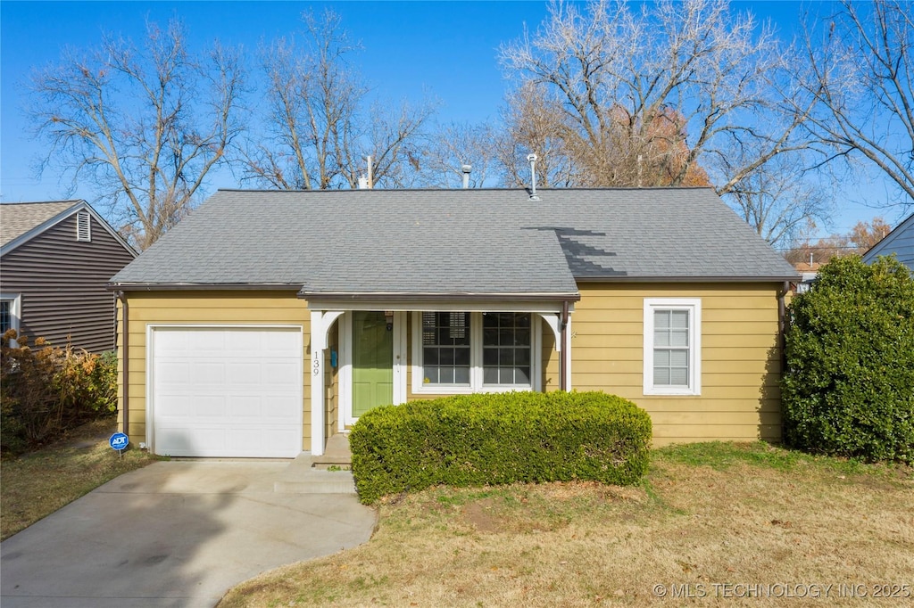 139 E 47th St, Tulsa, OK 74105 - view of front facade with a garage, driveway, roof with shingles, and a front lawn