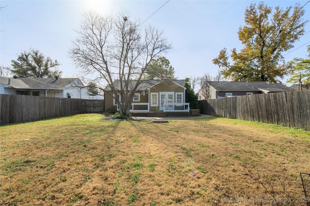 139 E 47th St, Tulsa, OK 74105 - fenced backyard with french doors and a patio
