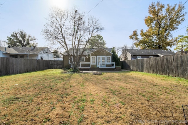 139 E 47th St, Tulsa, OK 74105 - fenced backyard with french doors and a patio