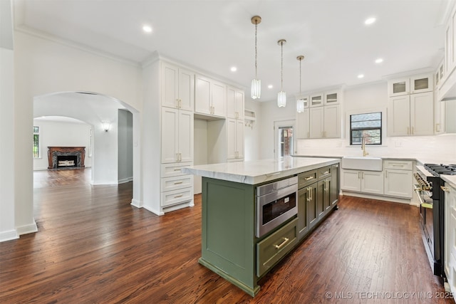 2605 S St Louis Ave, Tulsa, OK 74114 - kitchen with appliances with stainless steel finishes, white cabinetry, plenty of natural light, dark wood-type flooring, and recessed lighting