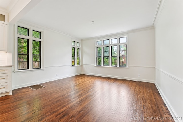 2605 S St Louis Ave, Tulsa, OK 74114 - unfurnished room featuring ornamental molding, plenty of natural light, and dark wood-style floors