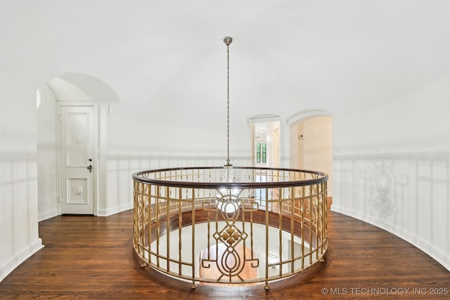 2605 S St Louis Ave, Tulsa, OK 74114 - corridor with wood finished floors, an upstairs landing, and arched walkways