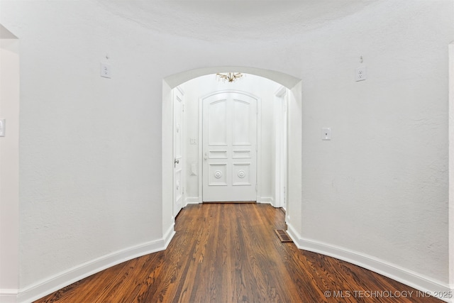 2605 S St Louis Ave, Tulsa, OK 74114 - hallway featuring arched walkways and dark wood-style flooring