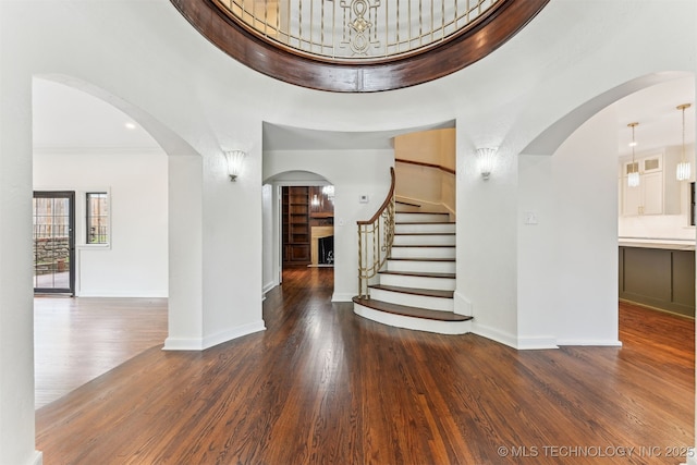 2605 S St Louis Ave, Tulsa, OK 74114 - entrance foyer with stairs, wood finished floors, arched walkways, and a high ceiling