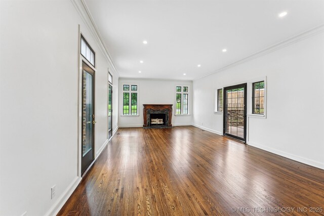 2605 S St Louis Ave, Tulsa, OK 74114 - unfurnished living room featuring crown molding, dark wood-style flooring, recessed lighting, and a premium fireplace